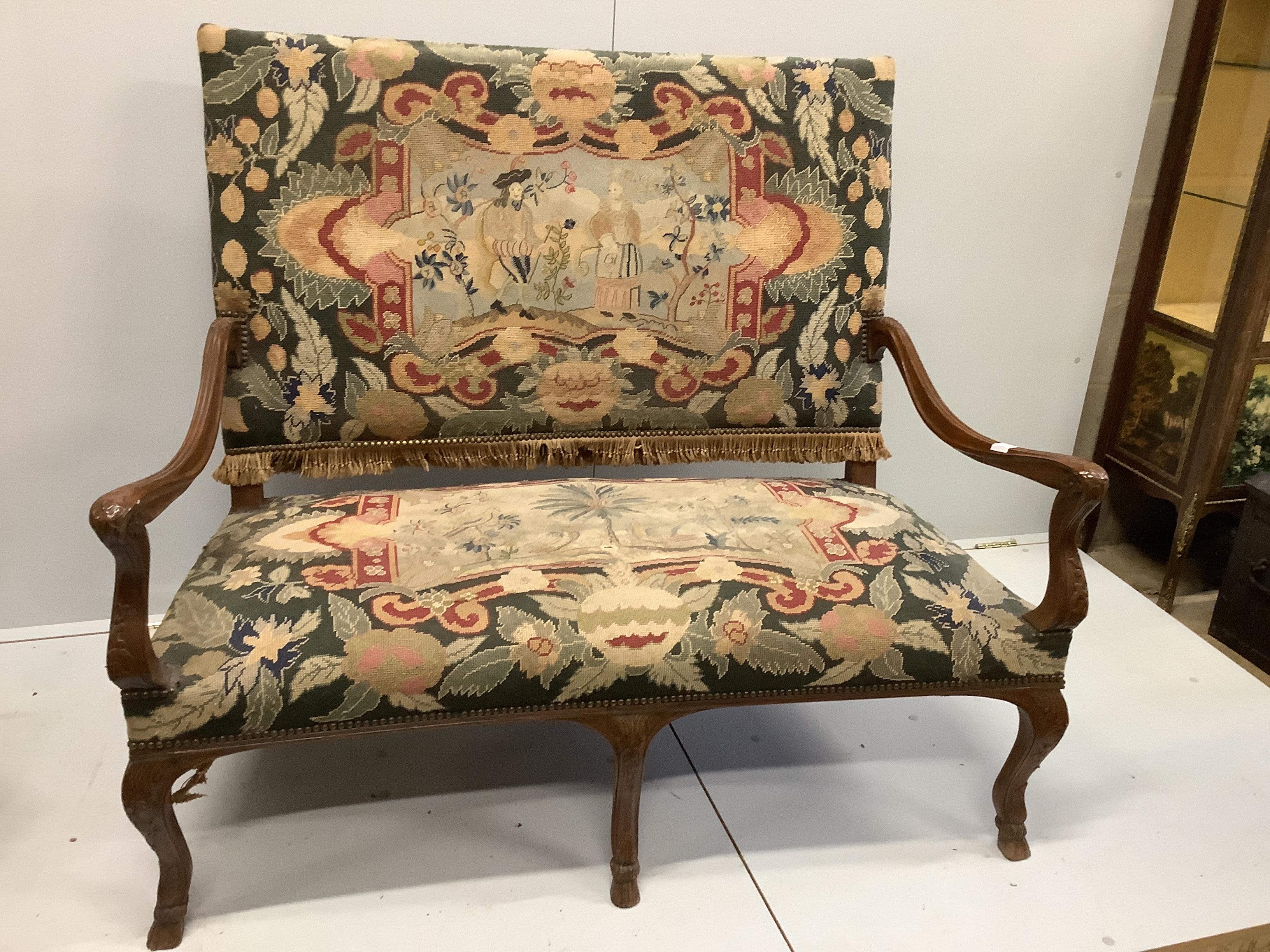 An 18th century style French upholstered walnut settee, length 116cm, width 66cm, height 112cm together with and a matching armchair